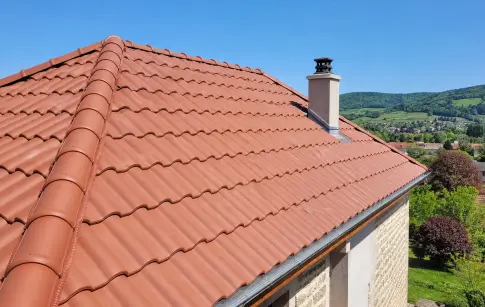 Toit de tuiles rouges sur une maison en pierre à la campagne